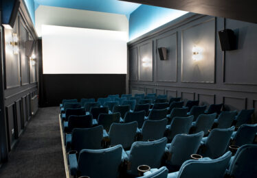 Blue chairs all in a row facing a cinema screen in the Regal Cinema, Youghal, Co. Cork