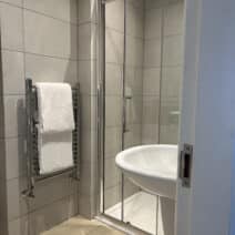 picture of bathroom with two towels on hand rail