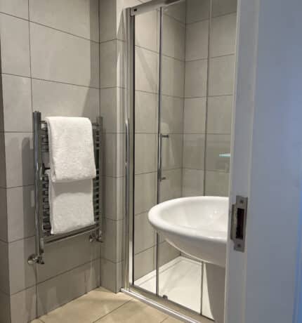 picture of bathroom with two towels on hand rail