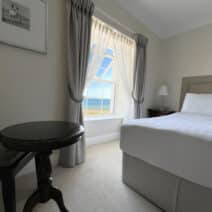 Seaview room with a double bed that can accommodate 2 people.