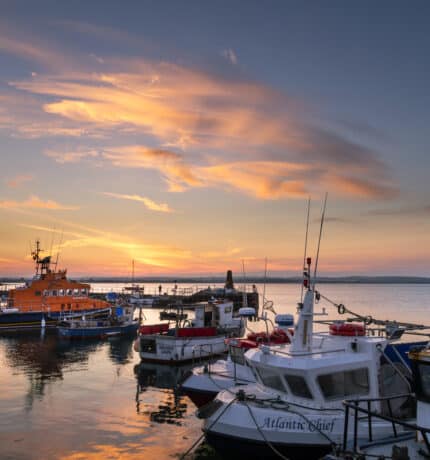 Boats in Ballycotton Harbour at sunset