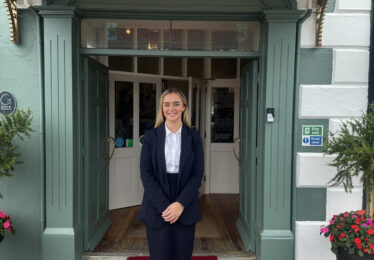 Staff member Chloe stands out the front of The Walter Raleigh Hotel