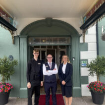 Staff members (L-R) Jack, Brian and Chloe stand out the front of The Walter Raleigh Hotel