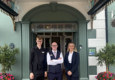 Staff members (L-R) Jack, Brian and Chloe stand out the front of The Walter Raleigh Hotel