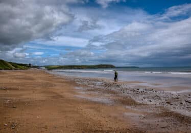 picture of beach with hotel in background