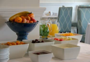 breakfast fruits and juice in jugs