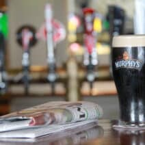 upclose pint of murphy's with newspaper on a bar