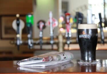 pint of murphy's with newspaper on a bar