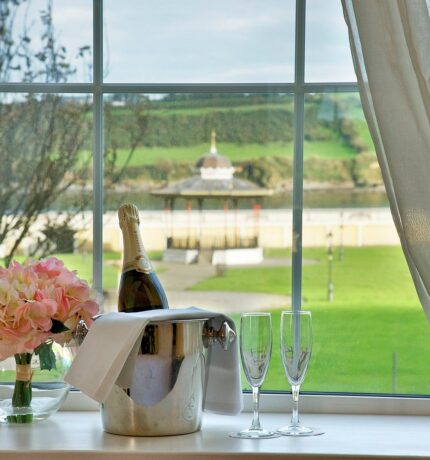 Bottle of Prosecco and two glasses overlooking the bandstand